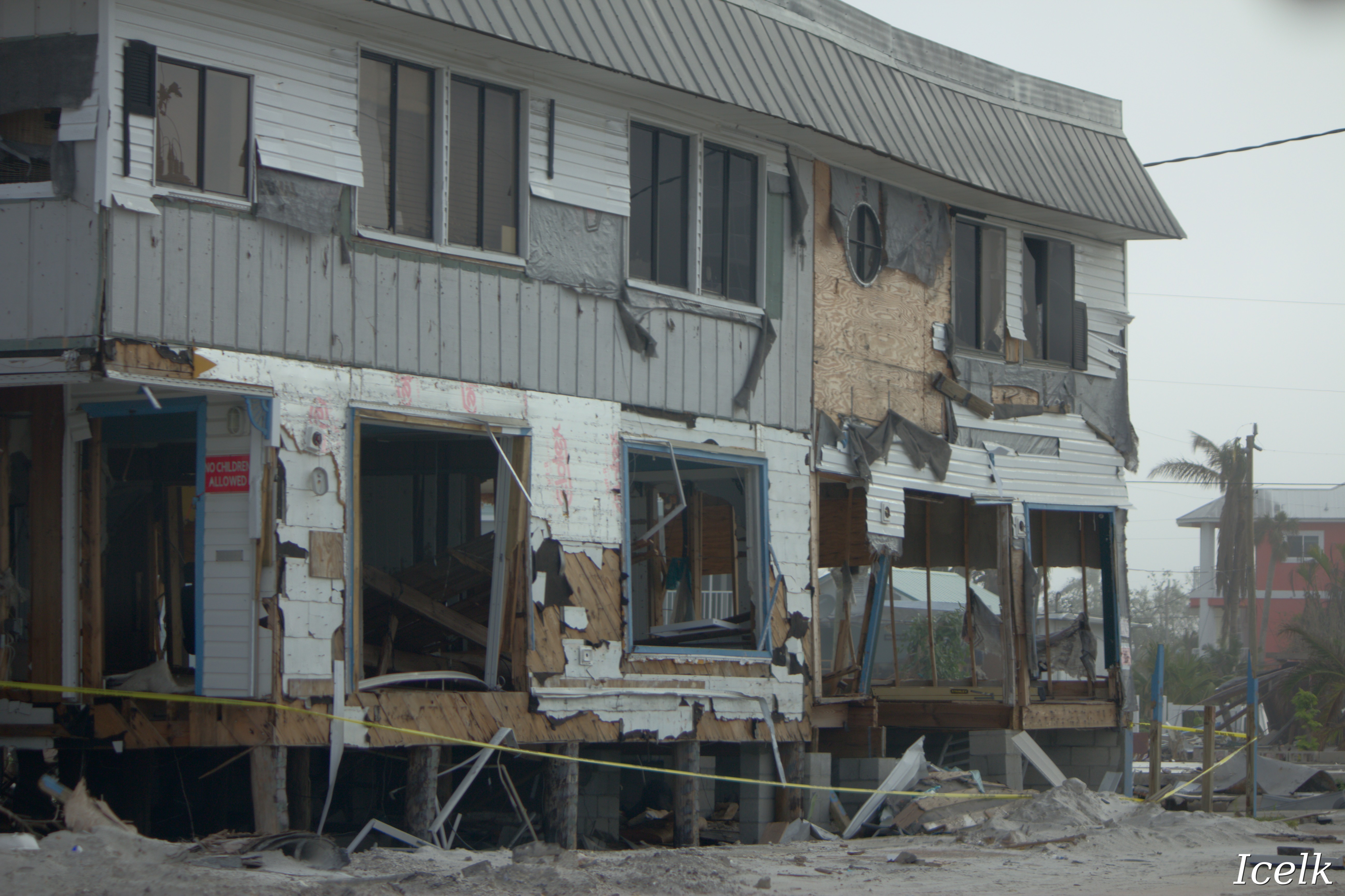 house with broken windows and walls on the ground floor